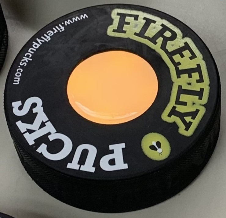 a real hockey puck with a motion triggered flashing core